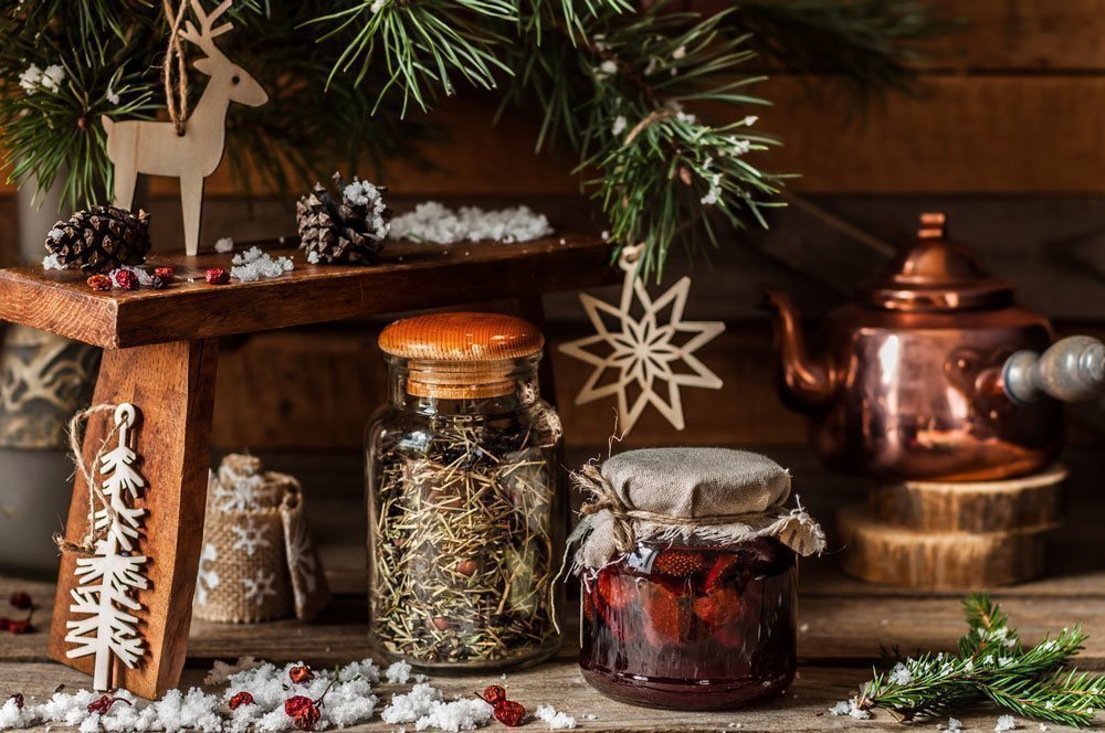 Homemade blends of herbal tea and fruit jam in jars for Christmas.