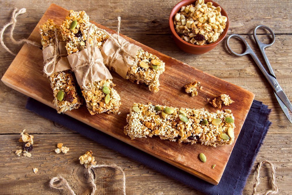 Homemade seeded muesli bars on a wooden board.