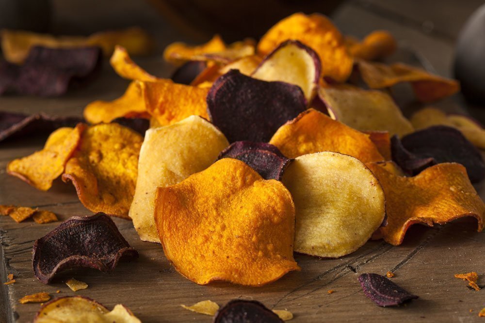 Homemade sweet potato and beetroot chips made in a food dehydrator.