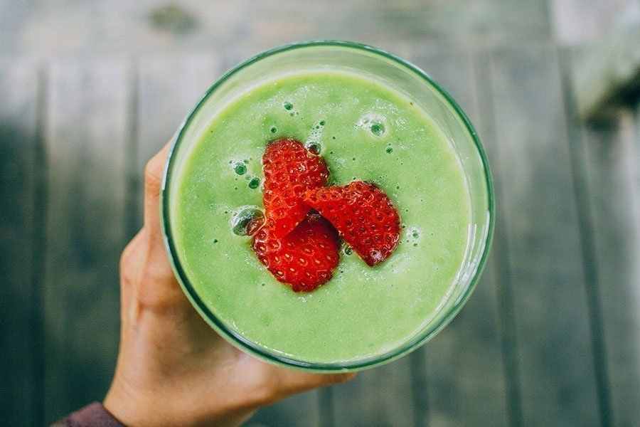 Fresh green smoothie made with Vitality 4 Life Personal Blender
